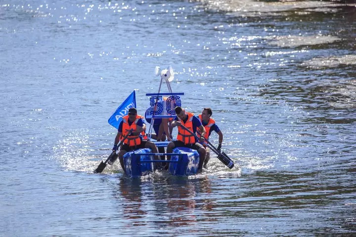 Nokians competing in a boat made out of recycled materials.