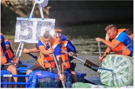 Nokians competing in a boat made out of recycled materials.