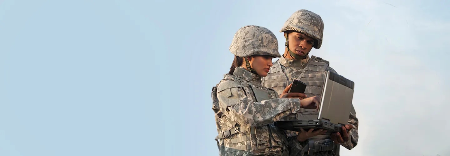 Two soldiers looking at a tablet device