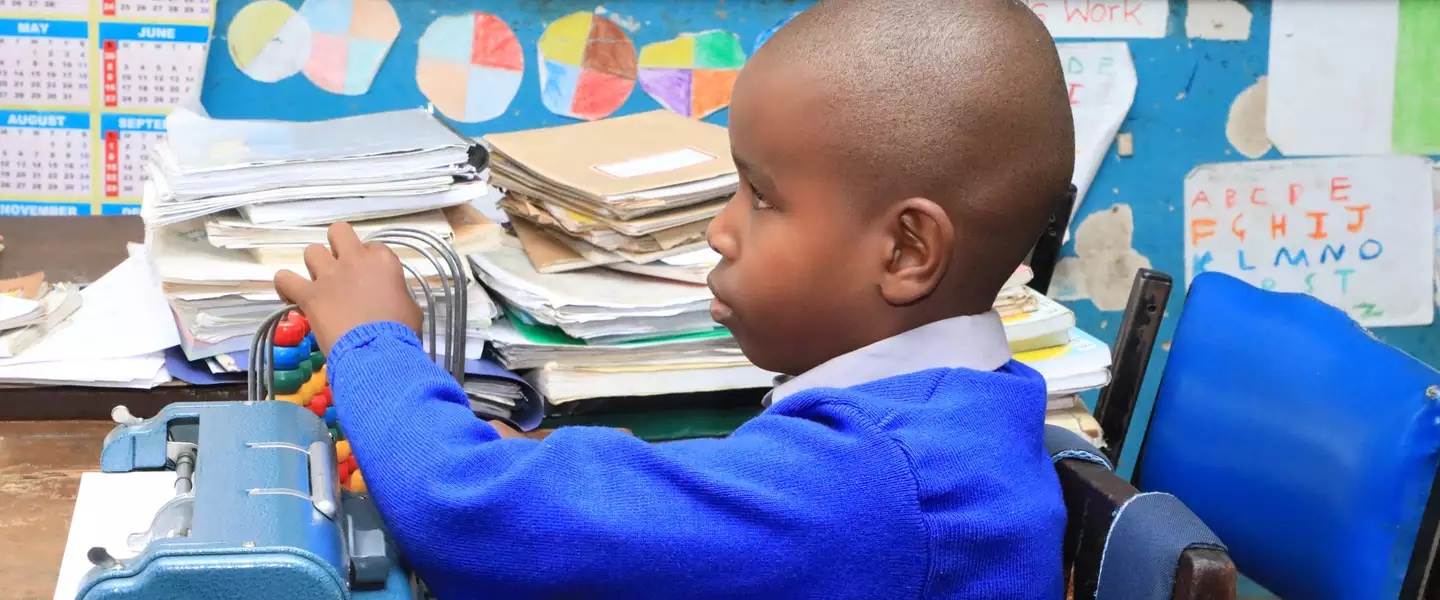 6-year-old Wesley Muturi in his class at Kilimani Primary School in Nairobi, using an abacus to count. / UNICEFKenya/2019/Ngochi 