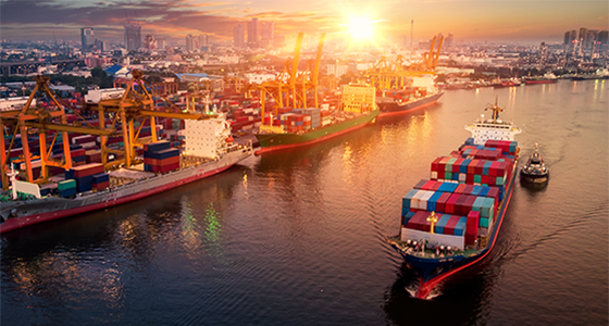 Ship leaving shipyard with cargo crates