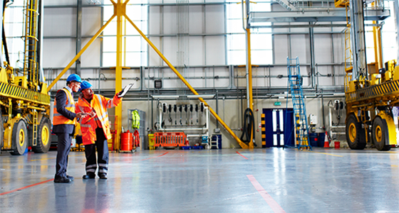Shipyard workers analysing in loading bay